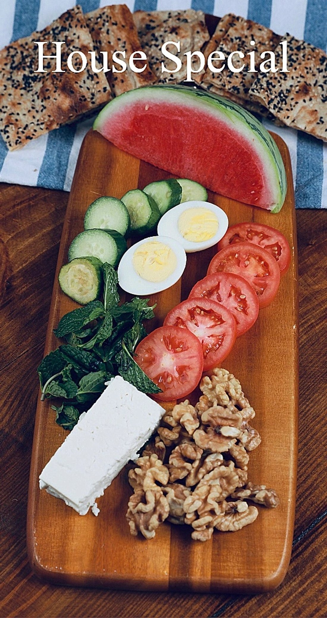 Persian breakfast platter with sangak, feta, walnuts, egg, tomatoes and cucumber
