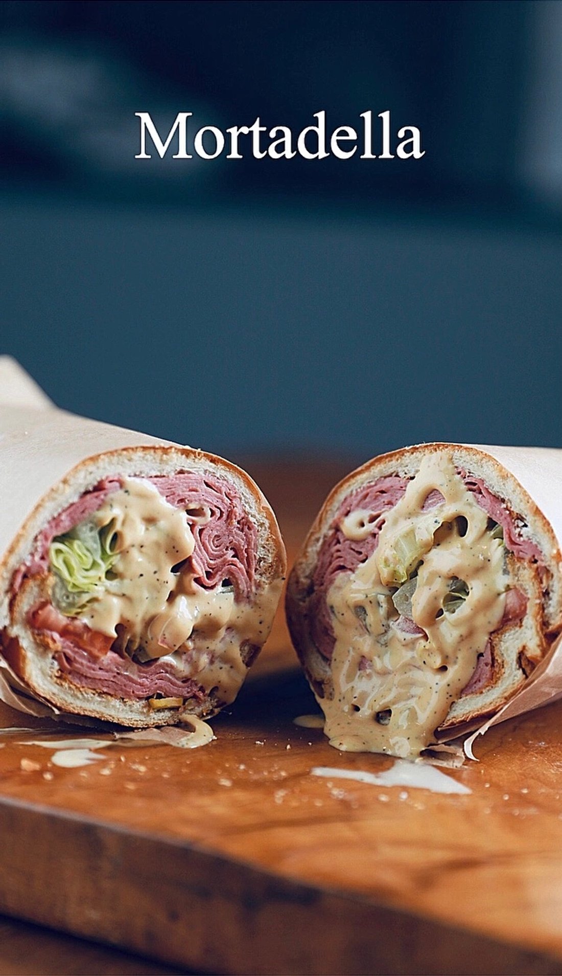 Mortadella sandwich on a wooden serving board